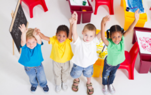 Early learners holding hands in air happy